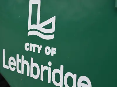 Green bin City Of Lethbridge logo close up