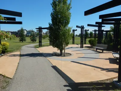 Sitting area at park with walking path and trees