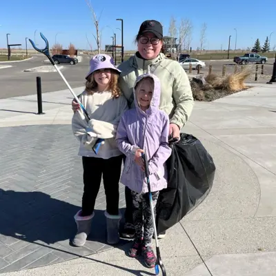 Earth Day garbage pick up woman and 2 children